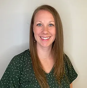 photo of Whitney Kramer, Part-time Clinical Educator, white woman, brown hair, blue eyes, smiling, wearing green shirt with white dots